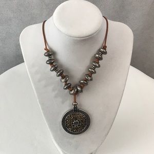 Metal beaded necklace with knotted leather string